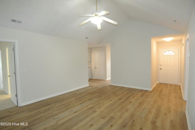 unfurnished room with ceiling fan, lofted ceiling, and light wood-type flooring