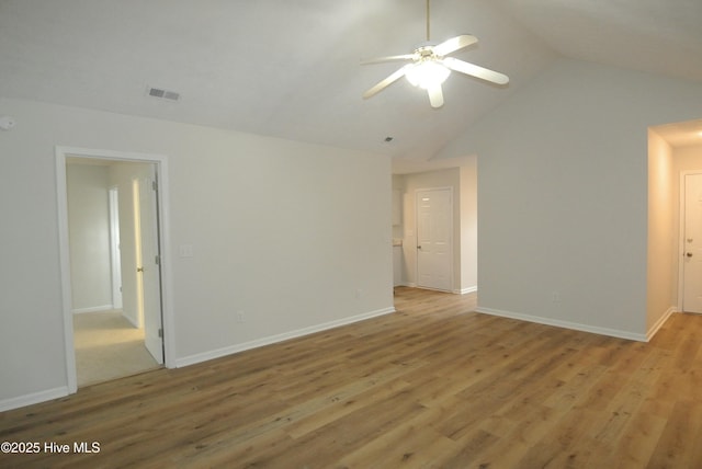 spare room with vaulted ceiling, light hardwood / wood-style floors, and ceiling fan