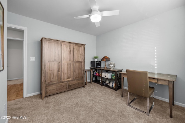 home office with ceiling fan and light carpet