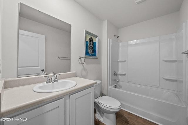 full bathroom featuring shower / tub combination, vanity, toilet, and hardwood / wood-style floors