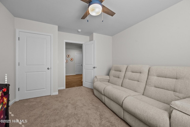 carpeted living room featuring ceiling fan