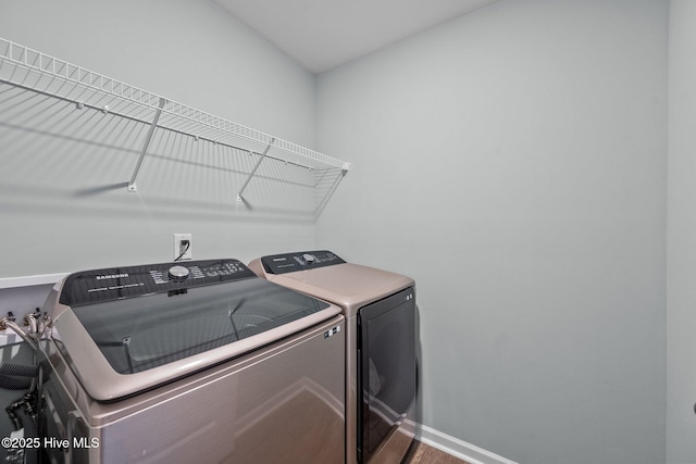 washroom featuring washer and clothes dryer and hardwood / wood-style flooring