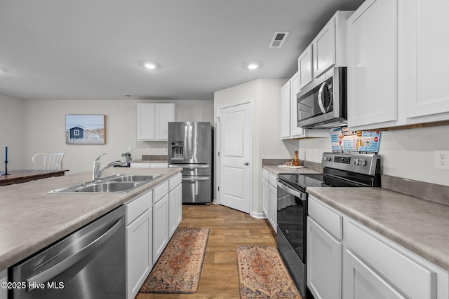 kitchen featuring white cabinets, sink, and stainless steel appliances