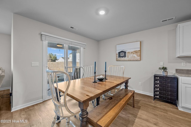 dining space with light hardwood / wood-style floors