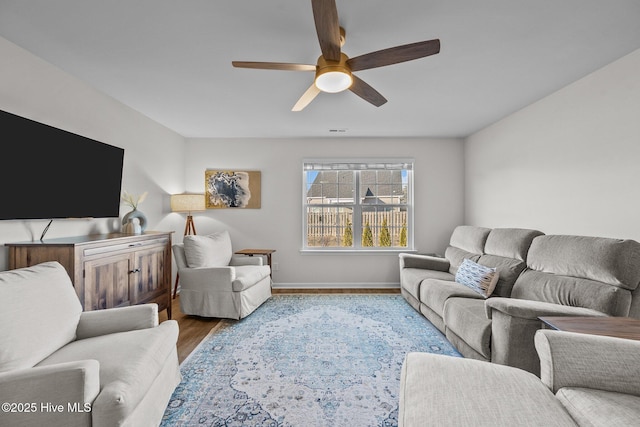 living room featuring hardwood / wood-style floors and ceiling fan