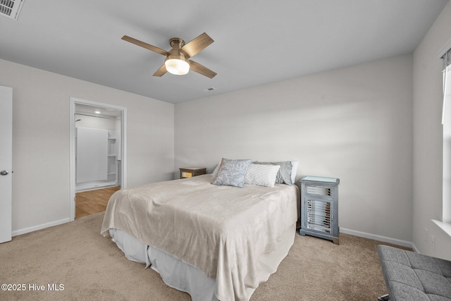 carpeted bedroom with ceiling fan and connected bathroom