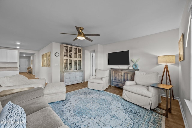 living room with ceiling fan and wood-type flooring