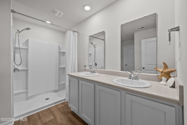 bathroom with a shower with curtain, vanity, and wood-type flooring