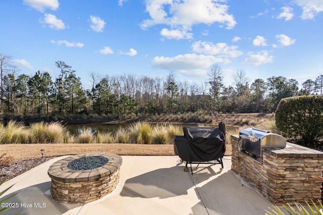 view of patio featuring area for grilling, a water view, and grilling area