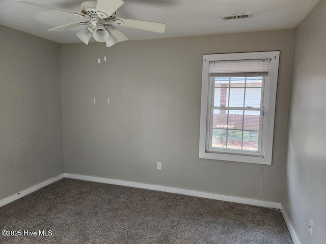 spare room with carpet flooring, ceiling fan, and a water view