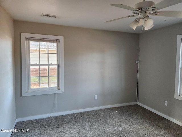 carpeted spare room featuring ceiling fan