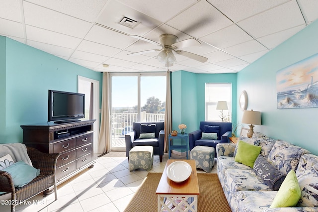 tiled living room featuring a paneled ceiling and ceiling fan