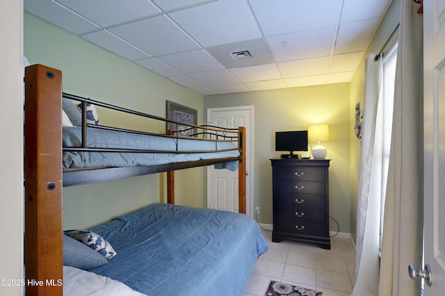 tiled bedroom with a drop ceiling