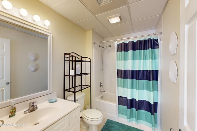 full bathroom with a paneled ceiling, vanity, toilet, and shower / tub combo with curtain