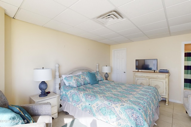 tiled bedroom with a drop ceiling