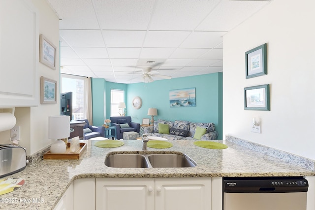 kitchen with ceiling fan, dishwasher, sink, a paneled ceiling, and white cabinets