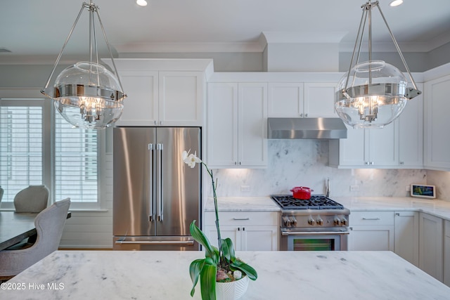 kitchen featuring backsplash, white cabinetry, a chandelier, and premium appliances