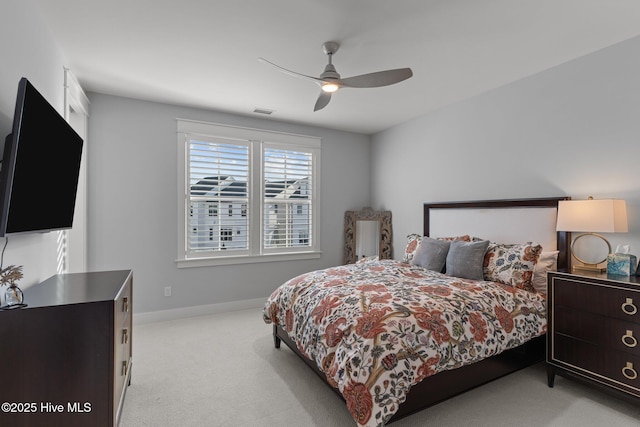 bedroom featuring light colored carpet and ceiling fan