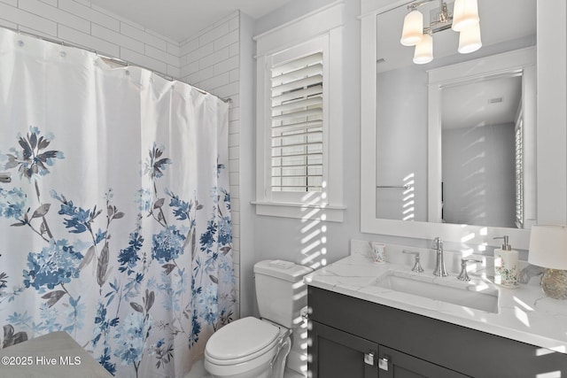 bathroom with a wealth of natural light, a shower with shower curtain, and toilet