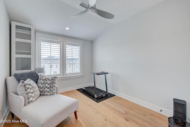 sitting room with vaulted ceiling, wood-type flooring, and ceiling fan