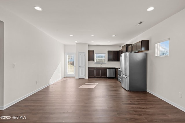 kitchen featuring dark brown cabinetry, sink, dark hardwood / wood-style flooring, and appliances with stainless steel finishes