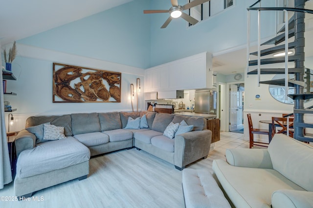 living room with high vaulted ceiling and ceiling fan