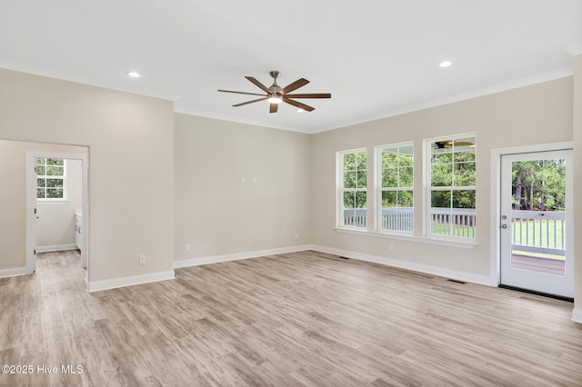 unfurnished living room with light wood finished floors, baseboards, visible vents, a ceiling fan, and crown molding