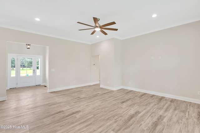 spare room featuring crown molding, a ceiling fan, light wood-style floors, baseboards, and recessed lighting