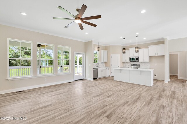 unfurnished living room featuring recessed lighting, crown molding, light wood-style flooring, and a ceiling fan