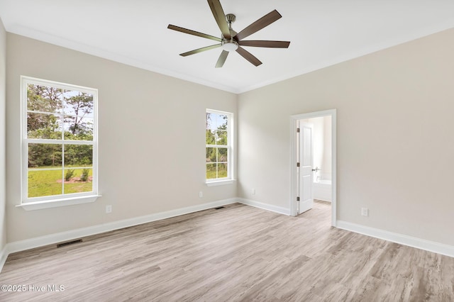 spare room with ceiling fan, crown molding, and light hardwood / wood-style flooring