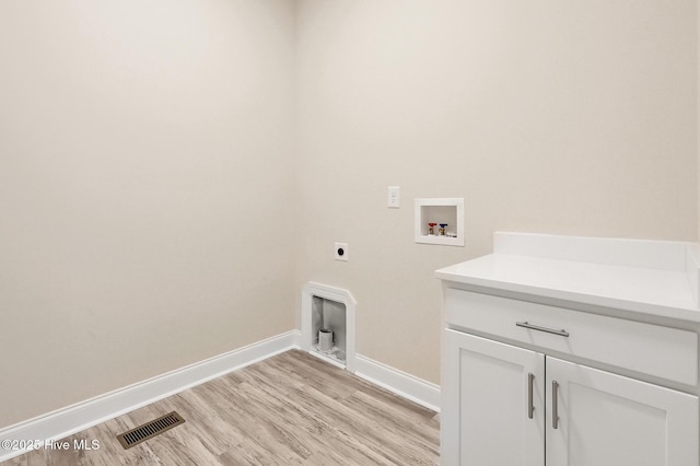 laundry area featuring light wood finished floors, visible vents, hookup for a washing machine, electric dryer hookup, and cabinet space