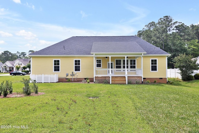 rear view of property with crawl space, a lawn, a ceiling fan, a deck, and roof with shingles