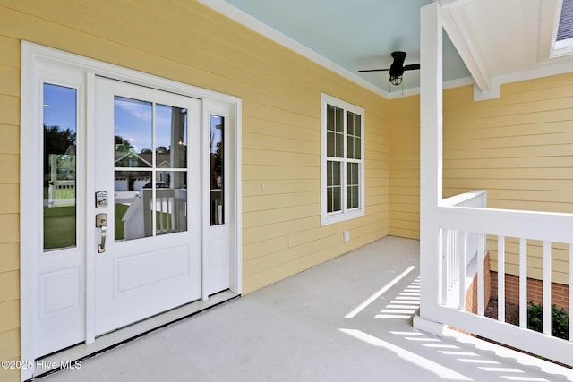 view of exterior entry featuring ceiling fan