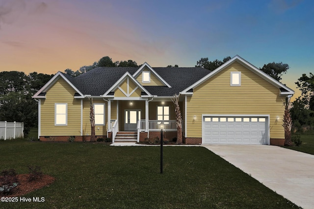 craftsman house with fence, concrete driveway, crawl space, a porch, and a lawn
