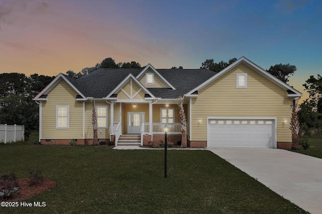 craftsman-style house with french doors, driveway, covered porch, a yard, and crawl space