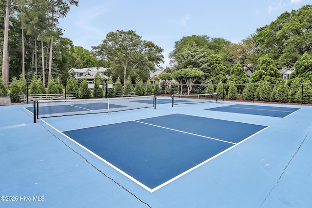 view of tennis court with fence and community basketball court