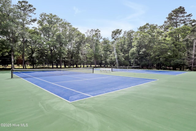 view of tennis court featuring fence