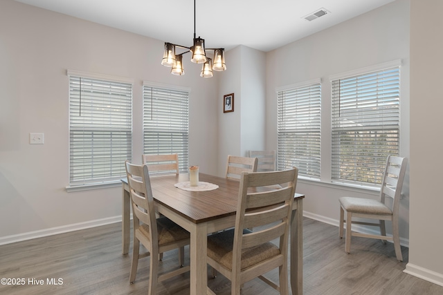 dining area featuring a chandelier and hardwood / wood-style flooring