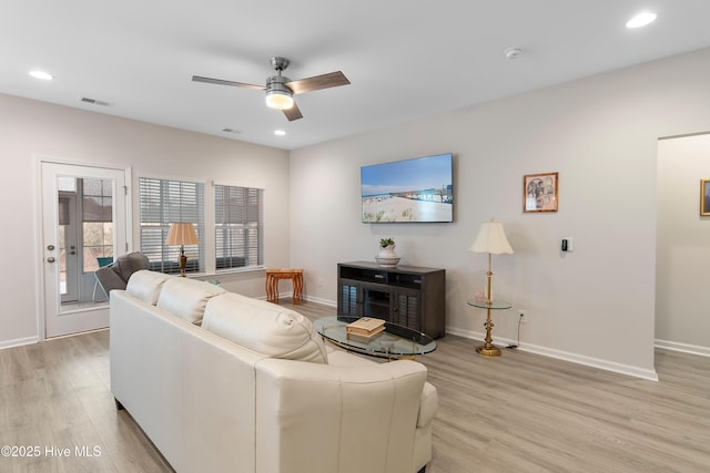 living room with ceiling fan and light wood-type flooring