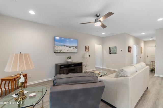 living room featuring hardwood / wood-style flooring and ceiling fan