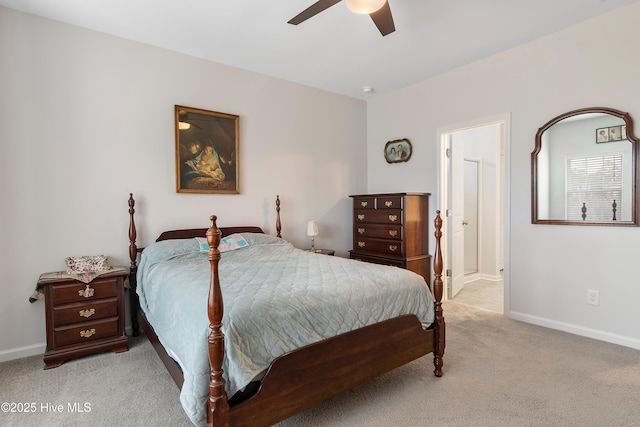 bedroom featuring connected bathroom, ceiling fan, and light colored carpet