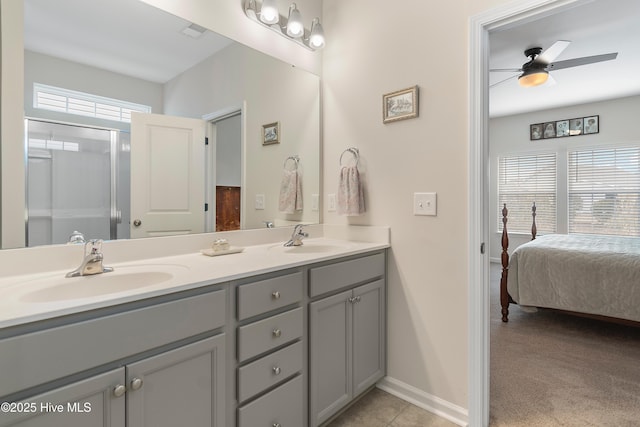 bathroom featuring vanity, a shower with door, tile patterned floors, and ceiling fan