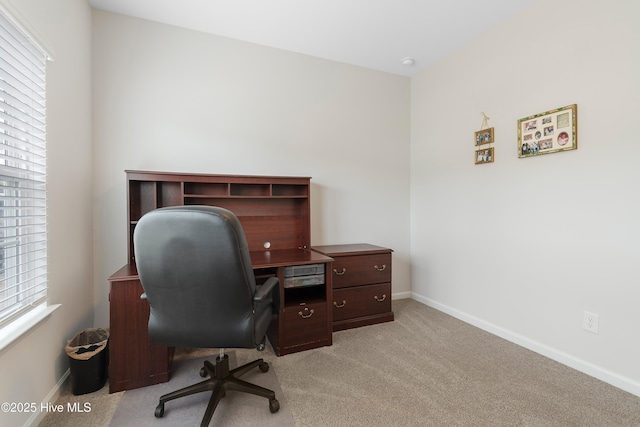 office area with light carpet and a healthy amount of sunlight