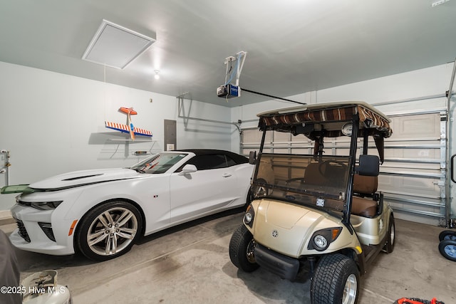 garage featuring electric panel and a garage door opener