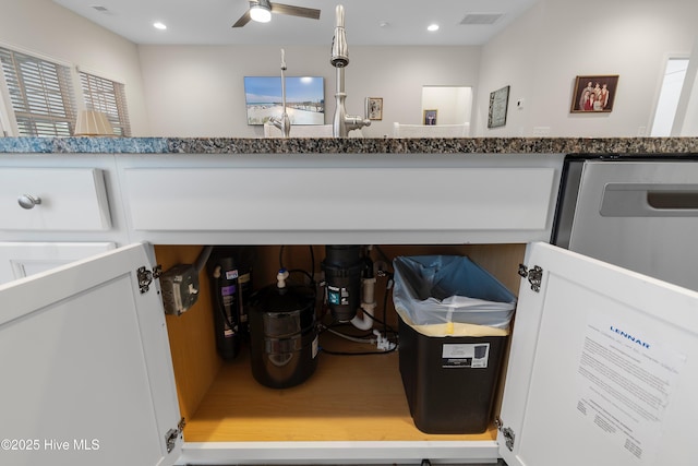 room details featuring white cabinets and ceiling fan