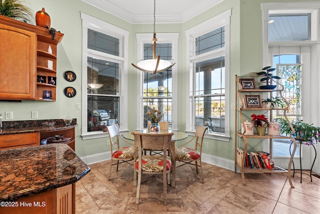 dining space featuring ornamental molding and plenty of natural light