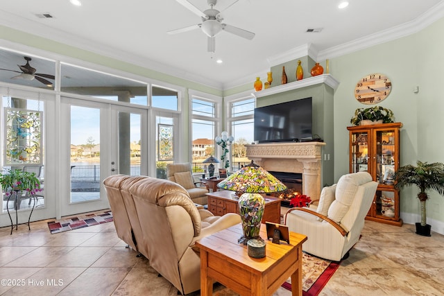 living room with ornamental molding, ceiling fan, french doors, and light tile patterned floors