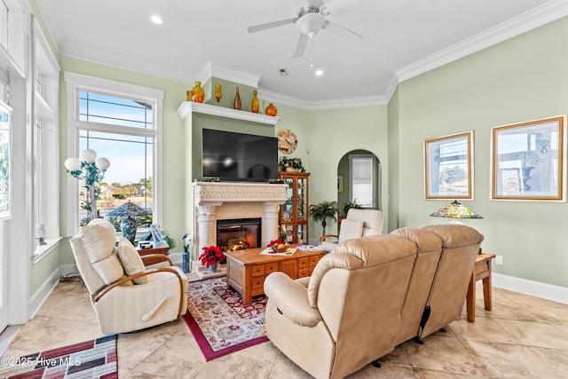 living room featuring ceiling fan, crown molding, and light tile patterned floors