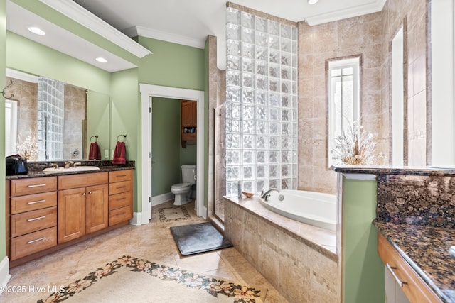 bathroom with tile patterned flooring, ornamental molding, toilet, vanity, and a relaxing tiled tub