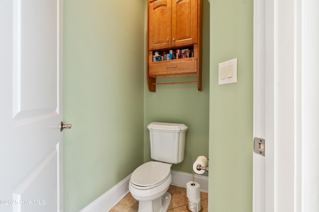 bathroom with toilet and tile patterned floors